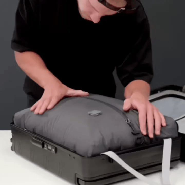 Pack3Ease vacuum compression bag with mini air pump: before and after compression comparison showing 60% more luggage space for 15+ clothing items.